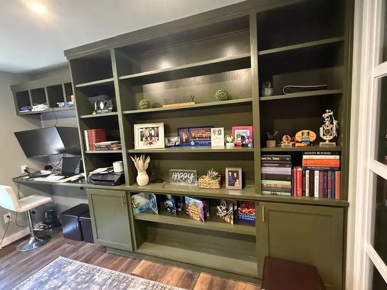 Olive built-in bookshelf and desk combination in a home office