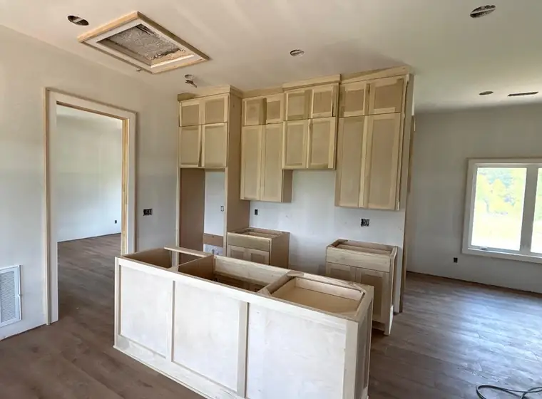 Unfinished cabinet boxes being set during a new-construction install
