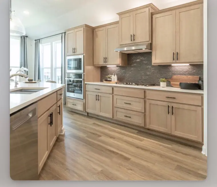 Light maple kitchen with a dark herringbone tile backsplash