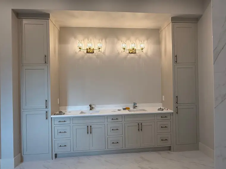 Painted double vanity flanked by full-height linen towers
