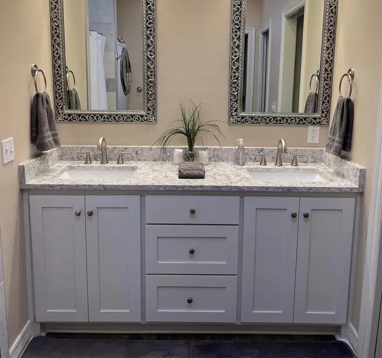 Grey shaker double vanity with a quartz countertop and two mirrors